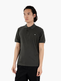 Polo with green logo tag