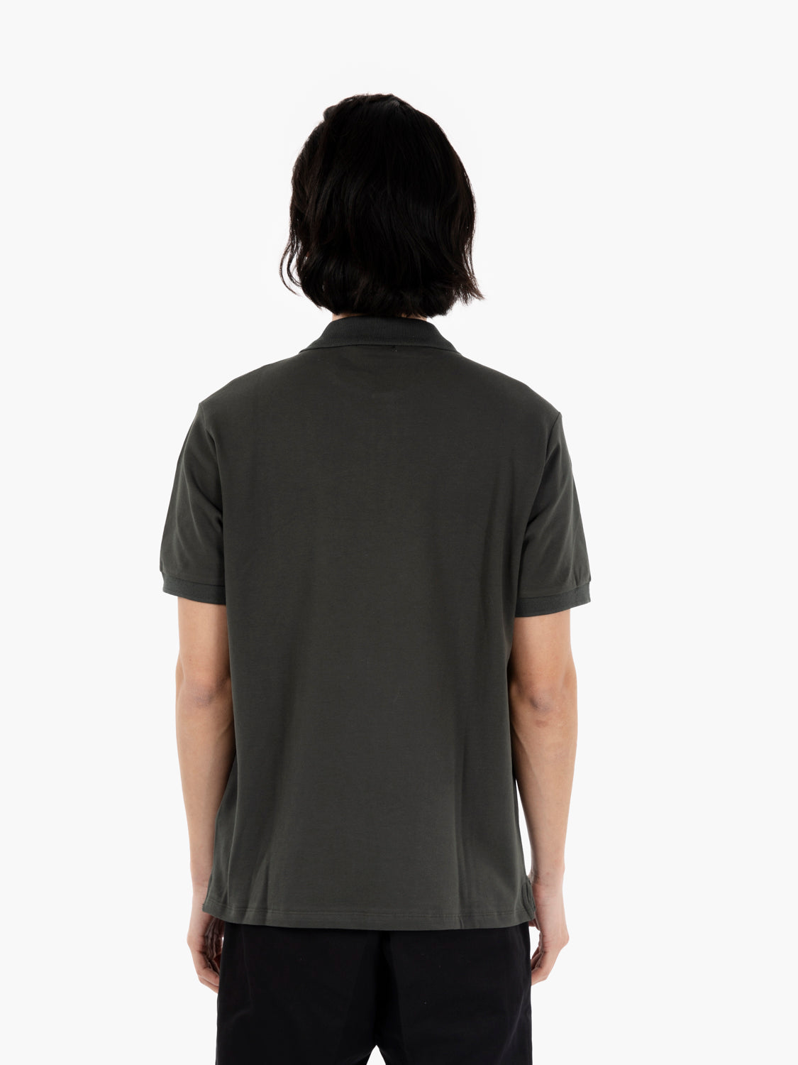 Polo with green logo tag