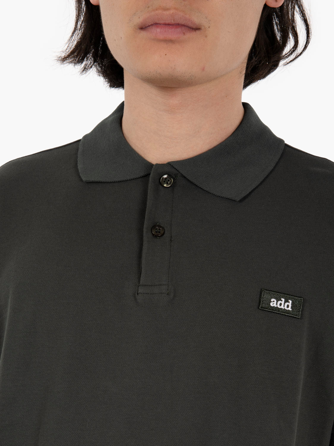 Polo with green logo tag