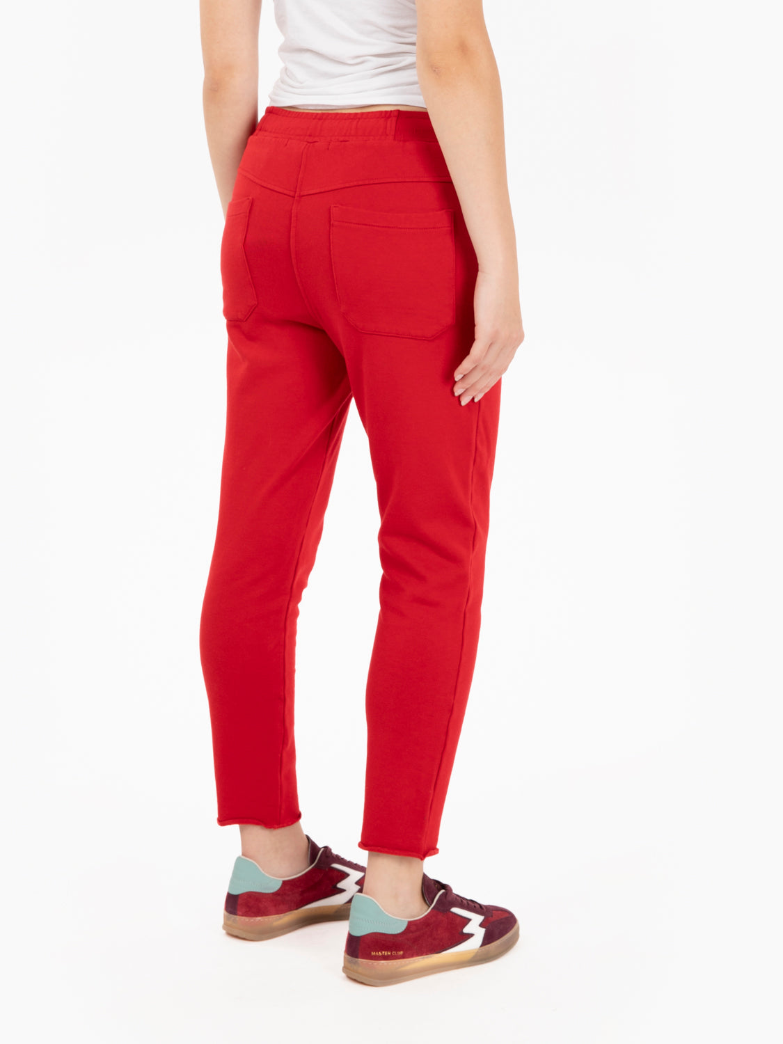 Pantaloni in felpa rossi con taglio a vivo sul fondo