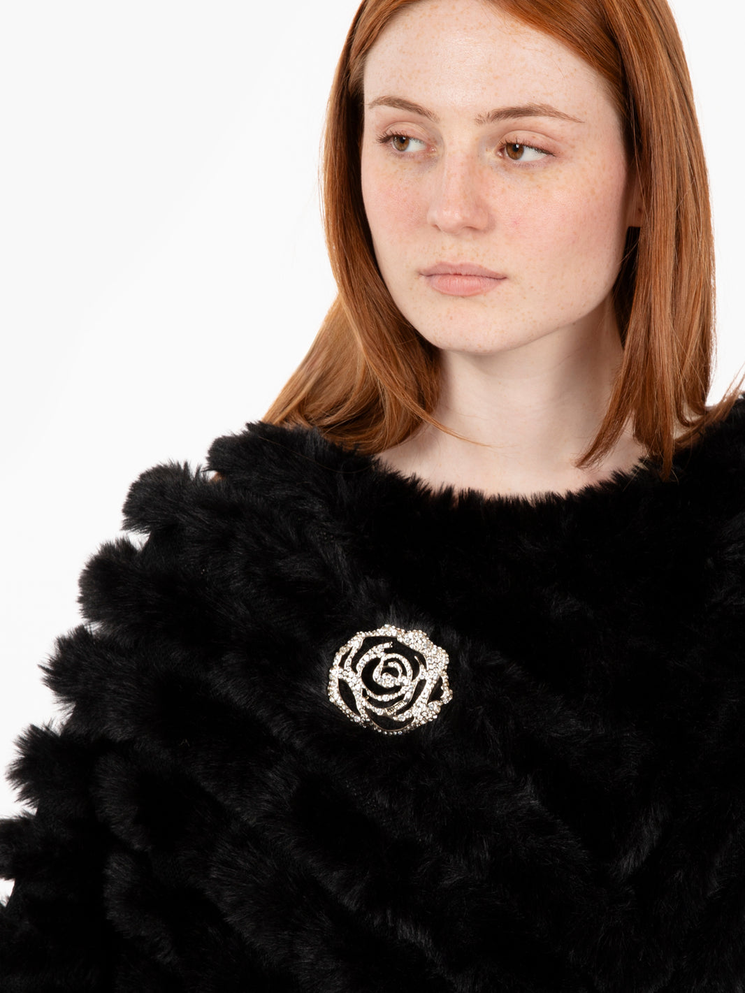Faux fur poncho with black brooch