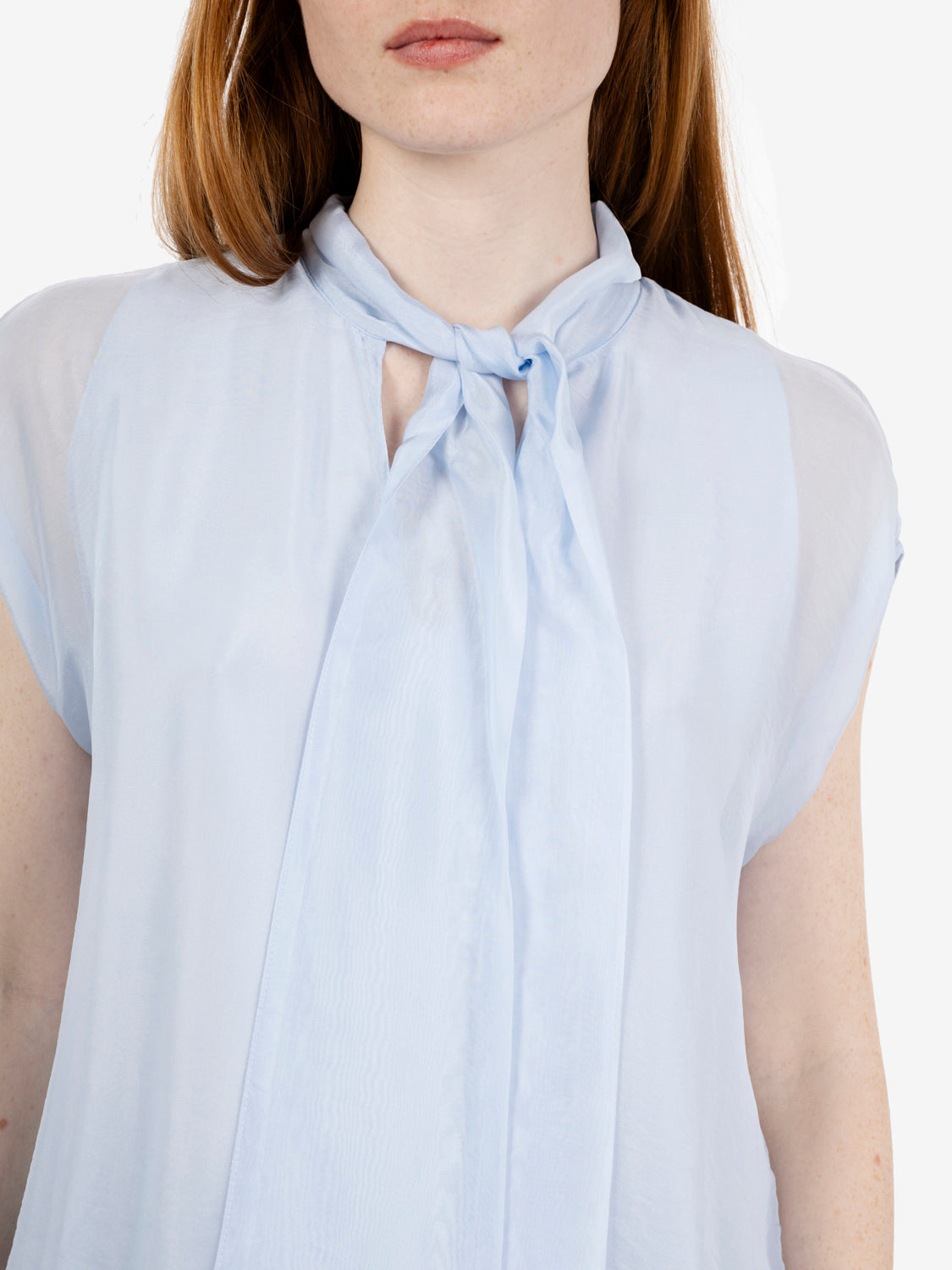 Sleeveless blouse with blue bow
